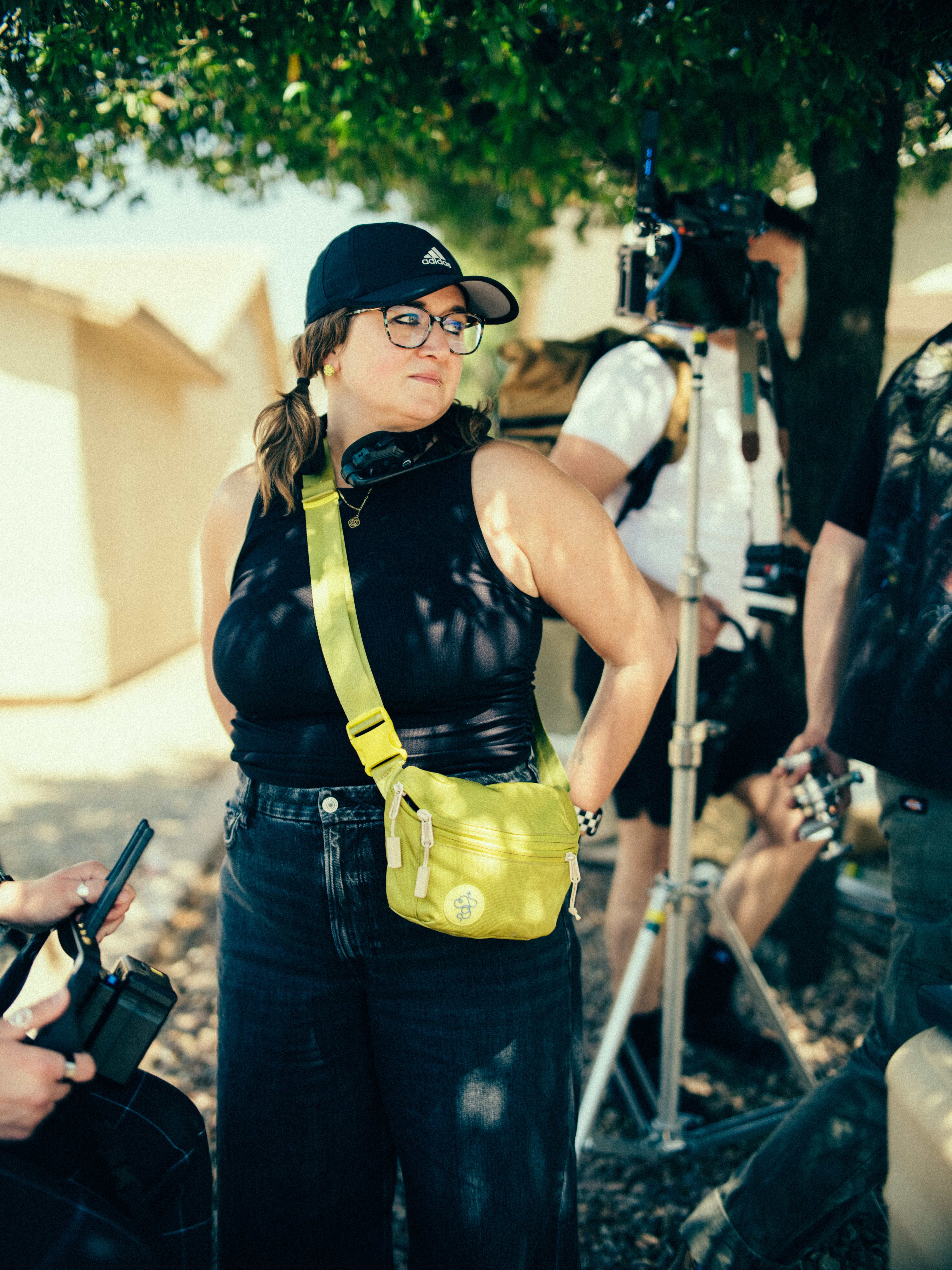 Chelsea Marine, owner of Check It Studio, on set beside a camera crew during a production